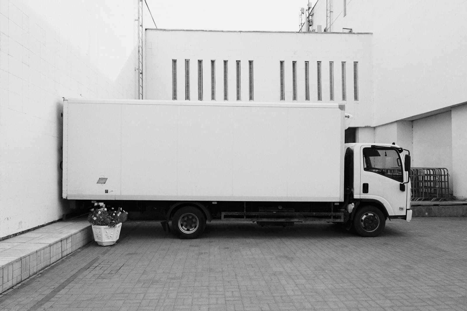 A box truck parked at a building